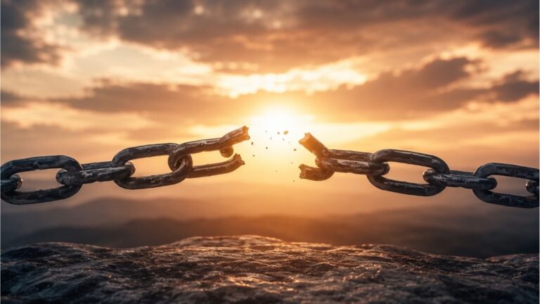Broken metal chain illuminated by a golden sunrise over distant mountains representing the central theme of The Broken Chain poem